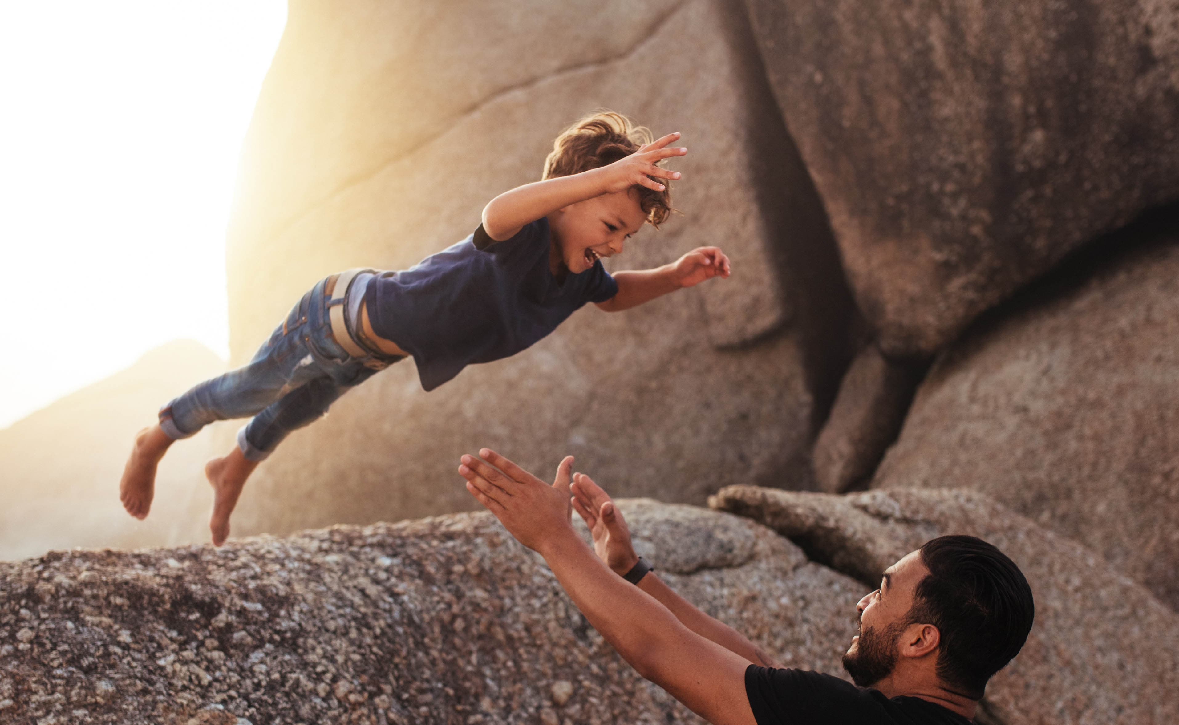 Boy leaping into father's arms